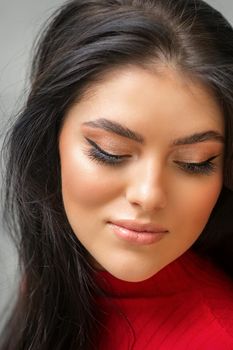 Portrait of young beautiful woman with long lashes and closed eyes after eyelash extensions.