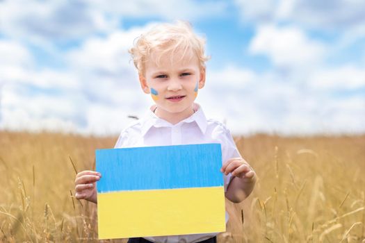 Stop War in Ukraine. Ukrainian boy with Ukrainina flag- yellow and blue stands against war.