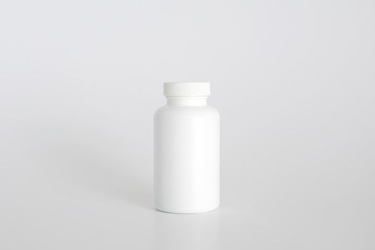 Pills bottle. White medical container for drugs, diet, nutritional supplements. White plastic jar for pills. Packaging mockup template. Free space, copy space.