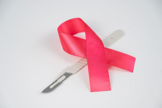 Pink altals ribbon and scalpel. Symbol of the fight against breast cancer.