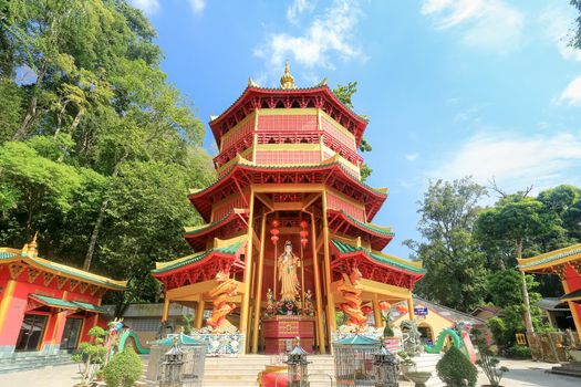 Chinese style pagoda with a giant statue of Guan Yin or goddess of compassion and mercy at Tiger Cave Temple (Wat Tham Seua) in Krabi, Thailand.