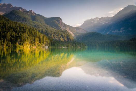Lake Tovel reflection symmetry in Trentino-Alto Adige, Dolomites, Italy