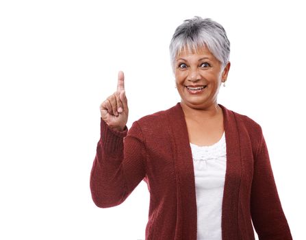 Mature lifestyle. Studio shot of a mature woman pointing to copyspace isolated on white.
