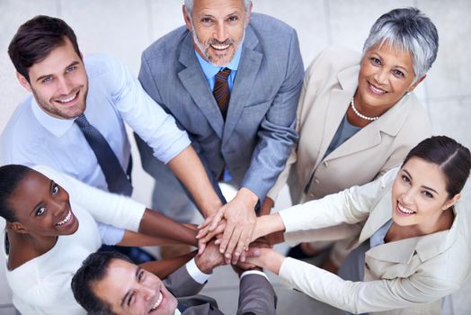 Business diversity and success. a group of coworkers with their hands in a huddle.