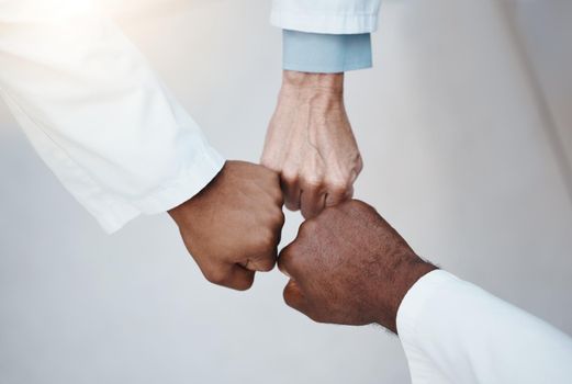 Trust, teamwork and hand fist together in solidarity with medical ethics in the workplace. Support of diverse professional healthcare work people in organization with respect and loyalty.