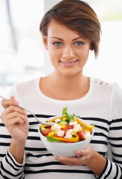 I cant wait to eat this. a young woman looking pleased with her salad.