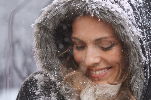 Loving the first snowfall. an attractive woman enjoying herself outside in the snow.