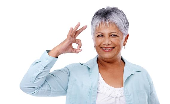 Mature lifestyle. Studio shot of a mature woman giving the ok sign isolated on white.
