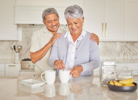 Coffee, couple and love with a senior woman and man enjoying retirement while together in the kitchen of their home. Happy, smile and romance with an elderly male and female pensioner making tea