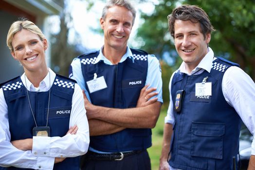 Your friendly local force. three smiling members of the police force.