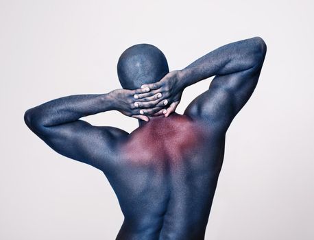 Muscle pain means its working. Rearview shot of a muscular man stretching showing heat sensitivity.