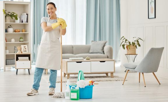 Happy woman cleaning home floor, house work and smile in home service mopping living room, job with gloves and happy to clean house apartment. Portrait of Asian cleaner or housewife housekeeping