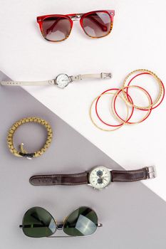 Flat lay contrast of mens and womens accessories.