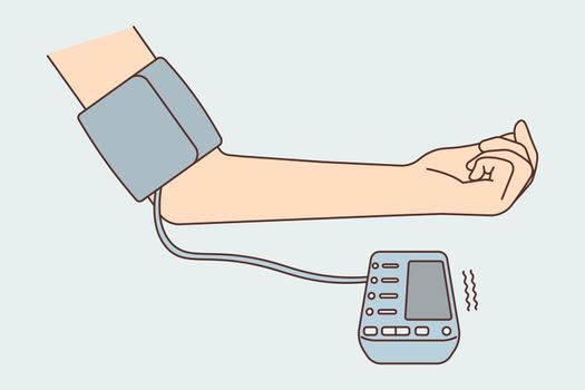 Patient hand with blood pressure monitor