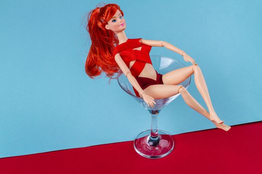 Sexy ginger doll bathing in martini glass.