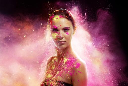 Mystical beauty. Conceptual shot of a beautiful young woman covered in multi-colored powder paint.