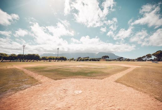 Empty baseball field, stadium or sport softball park for competition, training or tournament match. Sports, ball game or exercise, recreation or grass lawn nature area with pitch circle blue sky view