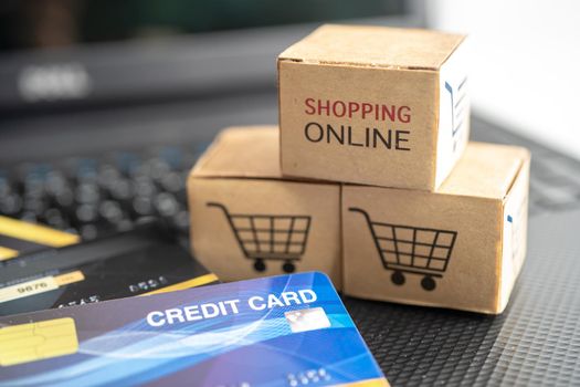 Shopping online box with credit card on laptop computer. Finance commerce import export business concept.