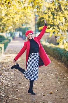 Cheerful woman in stylish outfit in park