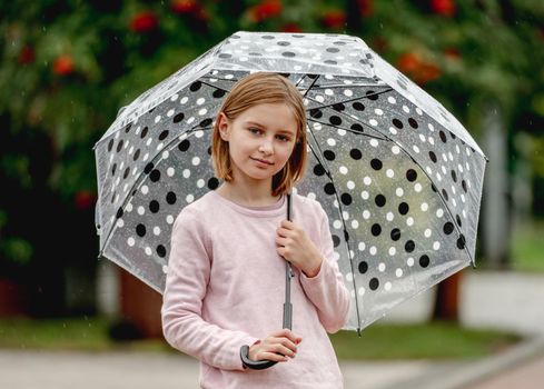 Preteen girl with umbrella