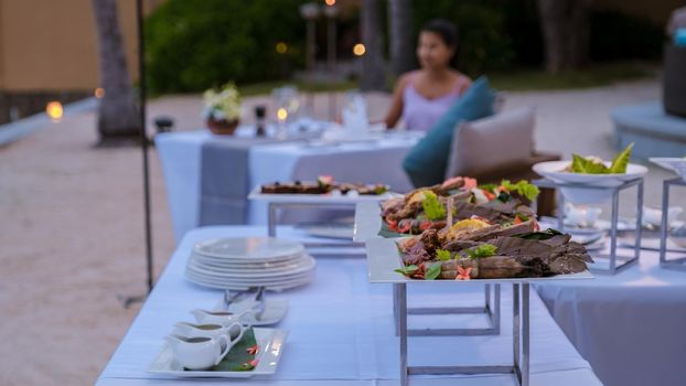 Luxury dinner table by the ocean with lobster, fish and thai food