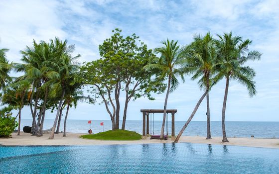 Hua Hin Thailand, tropical pool with palm trees at a luxury resort of Movenpick in Huahin