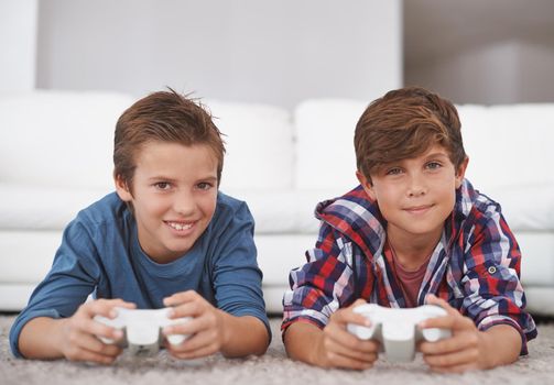 Gaming with my brother. Portrait of two young boys playing video games at home.