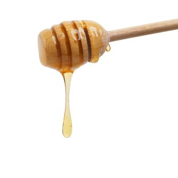 Food of the gods. Closeup shot of a honey spoon dripping delicious honey.