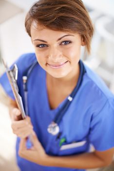 Shell treat you with care and confidentiality. Portrait of an attractive young doctor in scrubs holding a clipboard.