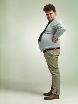 Im awesome. Full length shot of an overweight man viewed from the side.
