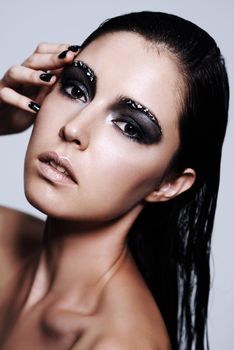 Her beauty shimmers and shines. Portrait of a beautiful young woman wearing metallic-colored makeup.