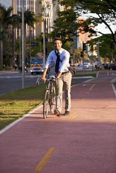 Getting to work by bike today. a businessman commuting to work with his bicycle.