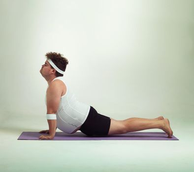 This upward facing dog pose is great. an overweight man doing yoga poses.