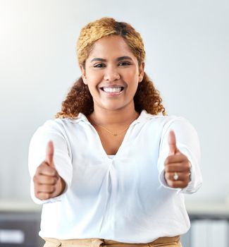 Thumbs up, thank you and motivation with a business woman and winner in her office with a smile. Hands, happy and success with a winning female employee saying yes and standing in her workplace