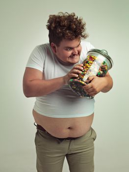 Whos my favourite candy, yes you are. an overweight man talking to his jar of candy.