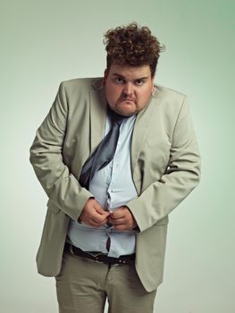 Must.close.shirt.an overweight man in a suit trying to close his shirt.