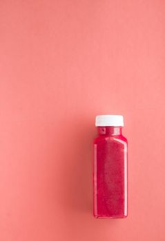 Detox superfood strawberry smoothie bottle for weight loss cleanse on.coral background, flatlay design for food and nutrition expert blog