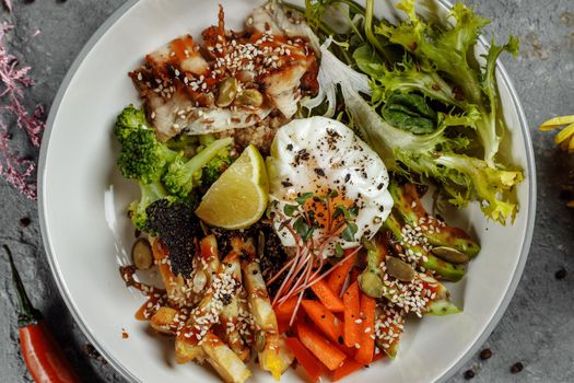 Healthy bowl - quinoa salad with tuna, broccoli, avocado on wooden rustic table. top view