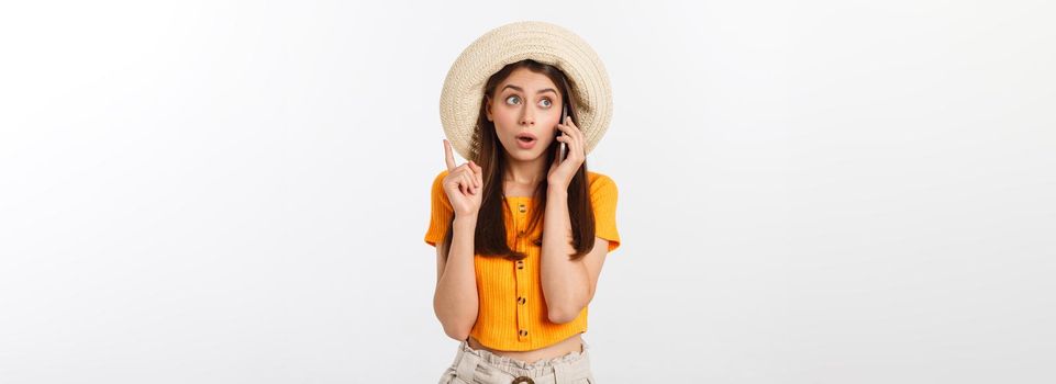 Picture of surprised voyage girl looking shock while holding phone in hands isolated over grey background