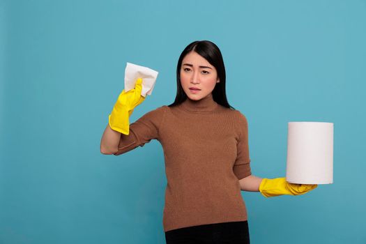 Angry sad and depressed asian houseworker holding tissue paper
