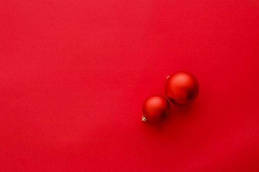 Christmas baubles on red flatlay backdrop, luxury winter holiday card background