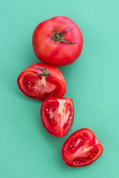 Fresh ripe red tomatoes on green background, organic vegetable food