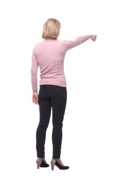 Back view of standing blonde woman in jeans and sweater