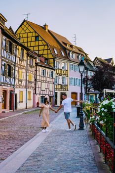Colmar, Alsace, France. Petite Venice, water canal and traditional half timbered houses.couple man and woman walking at the street during vacation Colmar is a charming town in Alsace, France. Beautiful view of colorful romantic city Colmar