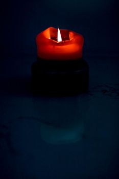 Red holiday candle on dark background, luxury branding design and decoration for Christmas, New Years Eve and Valentines Day