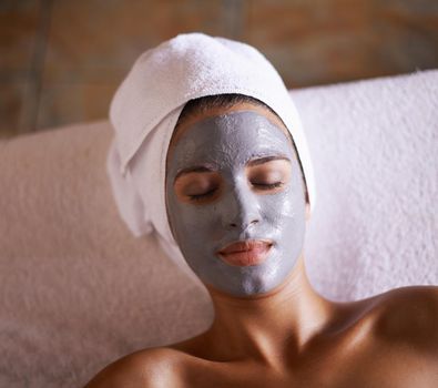 Serene skincare. A young woman relaxing during a facial treatment at a spa.