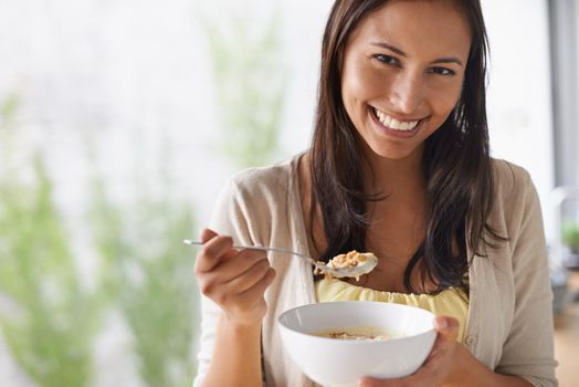 Every morning should start with a bowl of cereal. A lovely young woman enjoying a healthy salad.