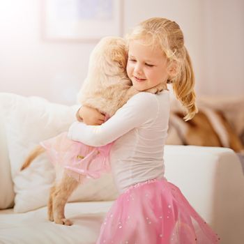 Youre my poochie, youre my pal. An adorable little girl with her puppy at home.