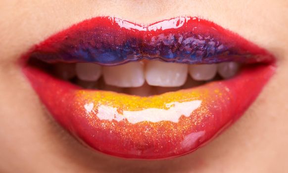 Shell have a kiss full of colour. a womans multicoloured lips.