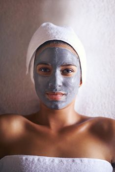 Rejuvenating her skin...A young woman relaxing during a facial treatment at a spa.